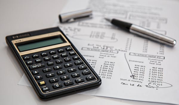 Calculator and pen on financial documents